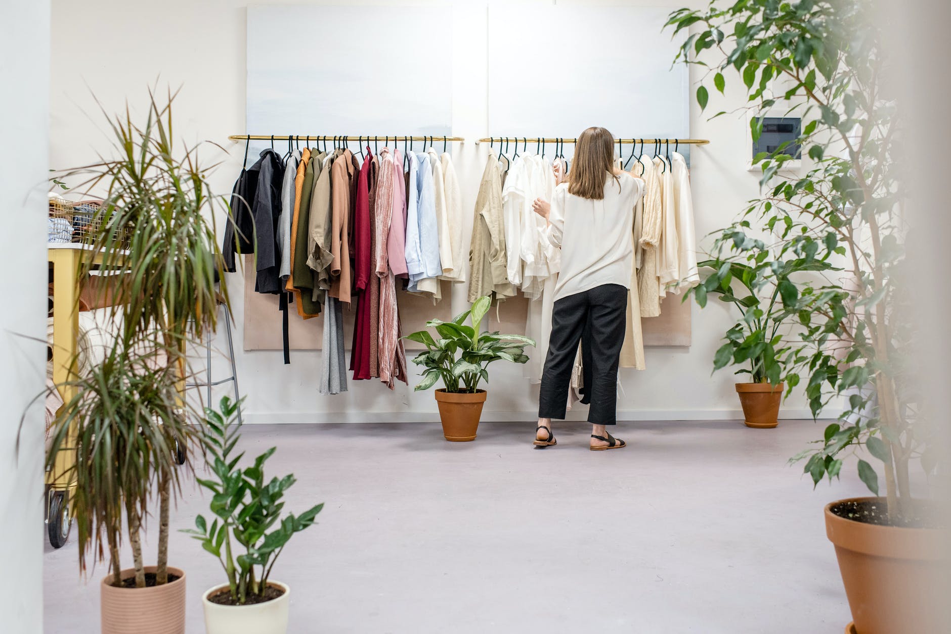 woman fixing clothes on the rack